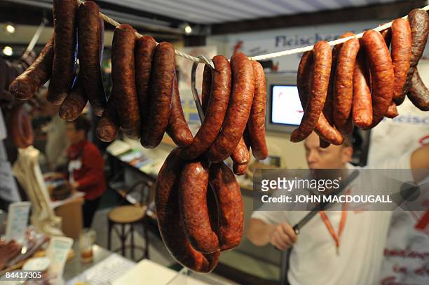 Vendor prepares to cut sausages for a client at the International Green Week Food and Agriculture Trade Fair in Berlin January 22, 2009. The...
