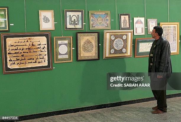 An Iraqi man looks at Arabic calligraphy during an exhibition at the minitsry of culture in central Baghdad on January 21, 2009. The exhibiton,...