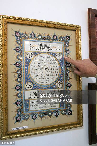 An Iraqi man looks at Arabic calligraphy during an exhibition at the minitsry of culture in central Baghdad on January 21, 2009. The exhibiton,...