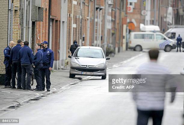 Police surround the area near a childcare centre where one child and one adult were killed in Dendermonde on January 23, 2009. One child and one...