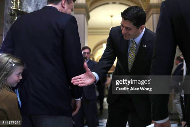 Speaker of the House Rep. Paul Ryan interacts with seven-year-old Evie Johnson of Charlotte, North Carolina, as he passes through the Statuary Hall...