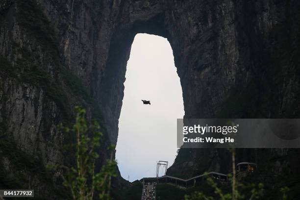Wingsuit flyer Zhang Shupeng of China jumps off a mountain during the 6th Carabao World Wingsuit Championship at Tianmen Mountain on Sepember 8, 2017...