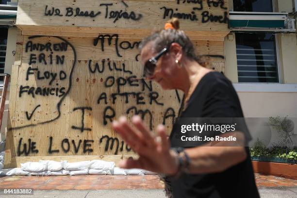Message reading "Will open after Irma" is written on plywood being used to cover the windows of a building as people prepare for the arrival of...