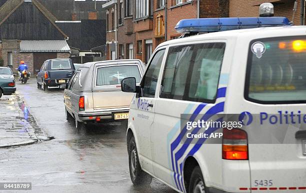 Two hearses and police car leave the children's day care center 'Fabeltjesland' in Sint-Gillis, Dendermonde on January 23, 2009. A man armed with a...