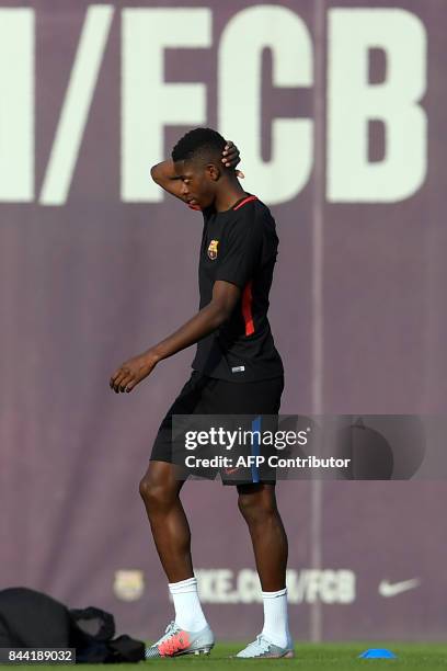 Barcelona's french forward Ousmane Dembele walks on the pitch during a training session at the Sports Center FC Barcelona Joan Gamper in Sant Joan...