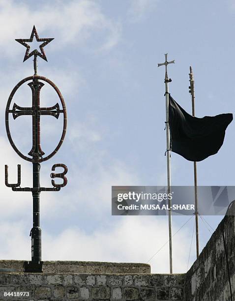 Black flag is raised at the Church of the Nativity in the West Bank city of Bethlehem on January 1, 2009 to mourn the killed Palestinians in the Gaza...