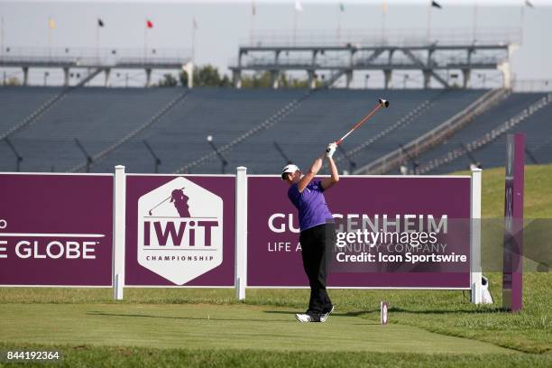 Golfer Stacy Lewis tees off the 18th hole with the 3rd turn grandstands from the Indianapolis Motor Speedway in the background during the second...