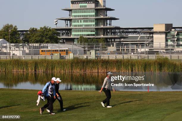 Golfers Lydia Ko and Stacy Lewis walk the 16th hole with the Indianapolis Motor Speedway Pagoda in the background during the second round of the Indy...