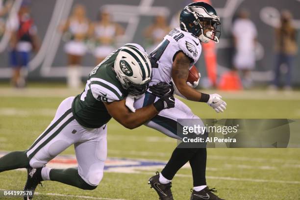 Linebacker Spencer Paysinger of the New York Jets makes a stop against the Philadelphia Eagles during their preseason game at MetLife Stadium on...