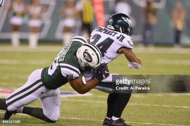 Linebacker Spencer Paysinger of the New York Jets makes a stop against the Philadelphia Eagles during their preseason game at MetLife Stadium on...