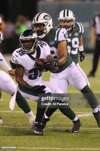 Linebacker Spencer Paysinger of the New York Jets makes a stop against the Philadelphia Eagles during their preseason game at MetLife Stadium on...