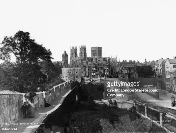 The medieval city walls around the old part of York in North Yorkshire, with York Minster in the background, circa 1890.