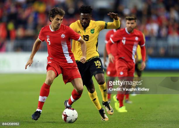 Dejan Jakovic of Canada battles for the ball with Ricardo Morris of Jamaica during an International Friendly match at BMO Field on September 2, 2017...