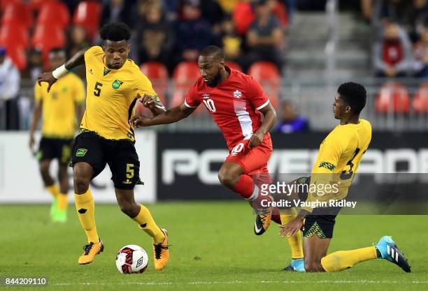David Junior Hoilett of Canada battles for the ball with Alvas Powell and Damion Lowe of Jamaica during an International Friendly match at BMO Field...