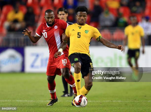 David Junior Hoilett of Canada battles for the ball with Alvas Powell of Jamaica during an International Friendly match at BMO Field on September 2,...