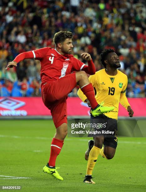 Michael Petrasso of Canada clears the ball with Ricardo Morris of Jamaica during an International Friendly match at BMO Field on September 2, 2017 in...