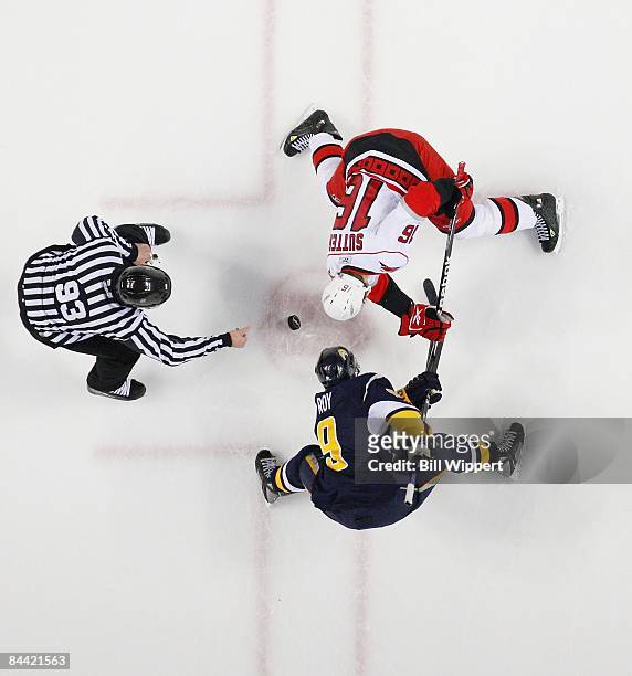 Derek Roy of the Buffalo Sabres takes a faceoff from linesman Brian Murphy against Brandon Sutter of the Carolina Hurricanes on January 17, 2009 at...