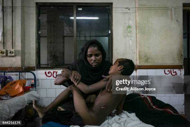 Nur Aysha holds her daughter, 8 year old Jubaira, in Chittagong Medical College Hospital September 8, 2017 in Chittagong, Bangladesh. Jubaira was...