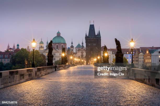 sunrise over charles v bridge - charles bridge stock-fotos und bilder