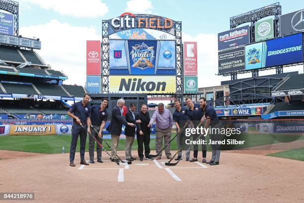 New York Rangers players Rick Nash and Ryan McDonagh along with Buffalo Sabres players Jason Pominville, Jack Eichel and Ryan O'Reilly pose for a...