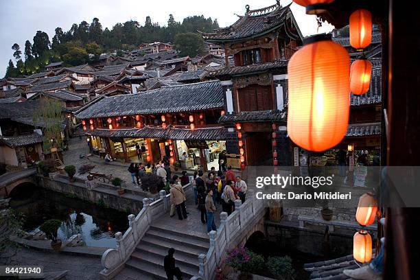 The old city centre in the town of Lijiang comes alive in the evening with dancing and activities for the Chinese tourists. Lijiang was the home of...