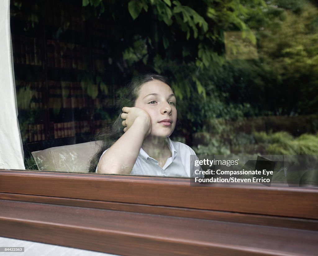 Girl gazing out of window