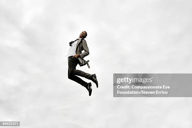 stylish man in mid-air - floating stock pictures, royalty-free photos & images