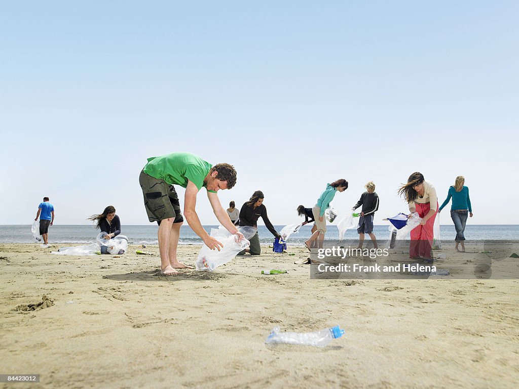 Young people collecting garbage on beach