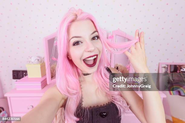 young woman with dyed pink hair smiling with mouth open in bedroom - open hair selfie stock pictures, royalty-free photos & images