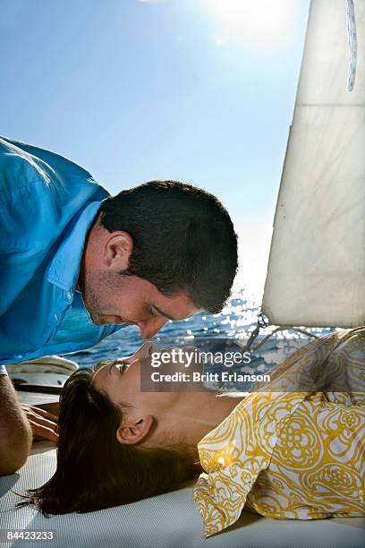 couple on sailboat, face to face - kiss booth stock-fotos und bilder