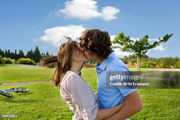 Teen lovers kissing in park