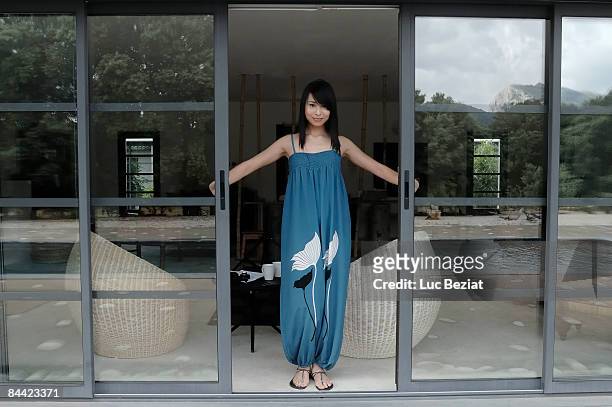 woman opening front door - glass door stock pictures, royalty-free photos & images