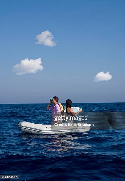 couple lost at sea on little boat - travel boundless stock-fotos und bilder