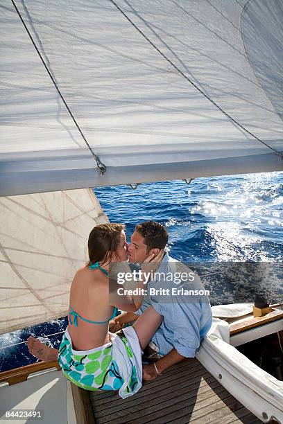 couple kissing on sailboat - kiss booth stock-fotos und bilder