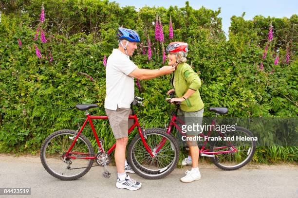 senior couple with bicycles - sports helmet stock pictures, royalty-free photos & images