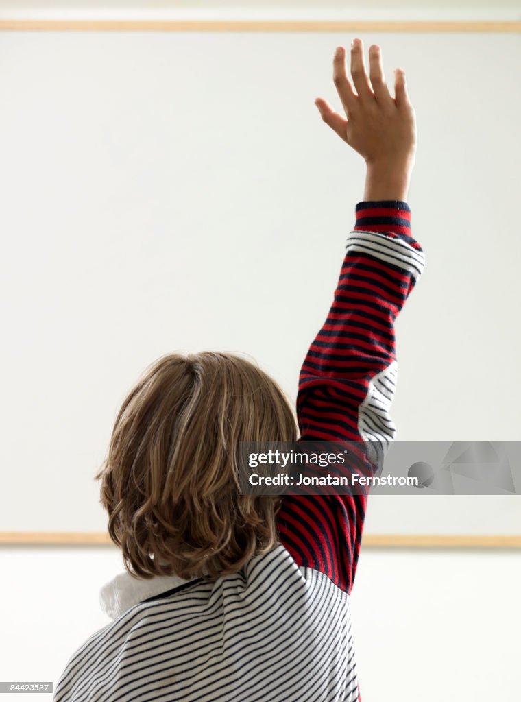 Boy Rasing Hand Boy Raising Hand In Classroom High-Res Stock Photo - Getty Images