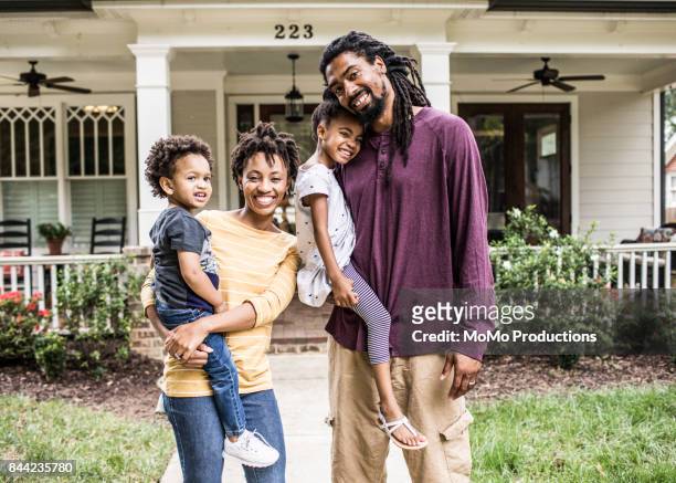 portrait of family in front of suburban home - millennial generation stock-fotos und bilder