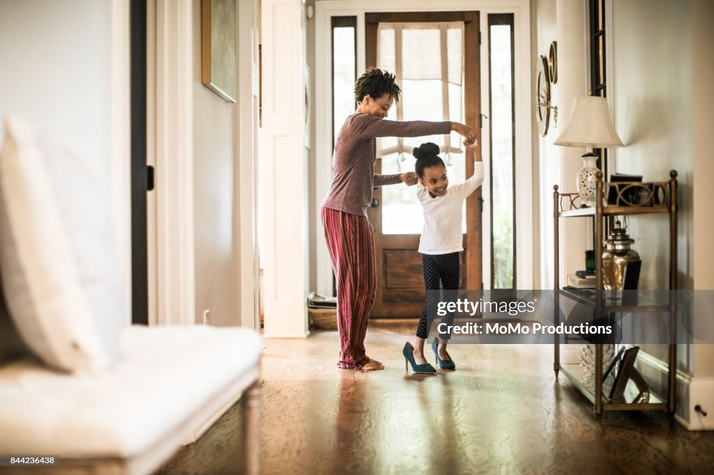 Daughter wearing mother's high heels