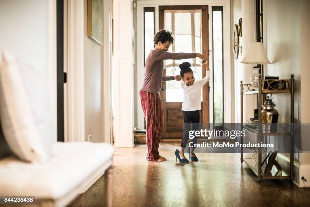 daughter wearing mother's high heels - dancing shoes stock pictures, royalty-free photos & images