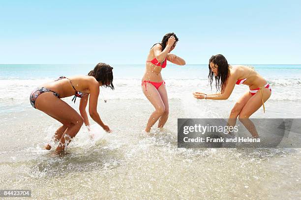 three girls splashing each other - helena klotz stock-fotos und bilder
