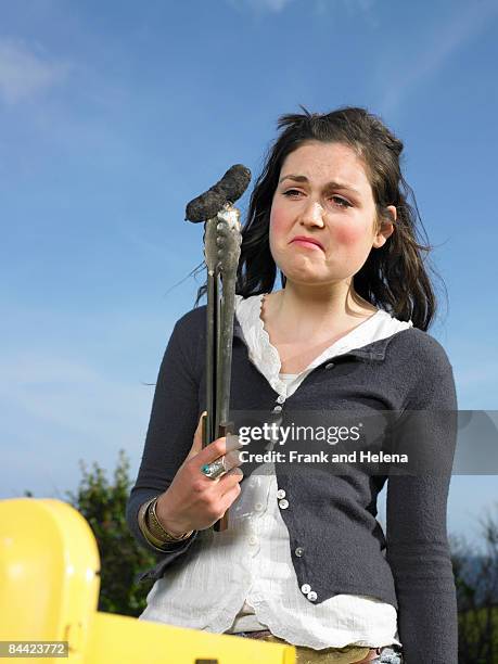 woman looking at burnt sausage - burnt cooking stock pictures, royalty-free photos & images