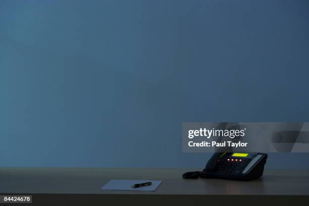 telephone on desk at night - landline phone imagens e fotografias de stock