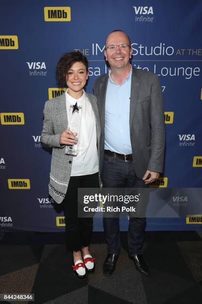 Founder and CEO of IMDb Col Needham presents actress Tatiana Maslany with The IMDb 'Fan Favorite' STARmeter Award In Toronto At The Visa Infinite...