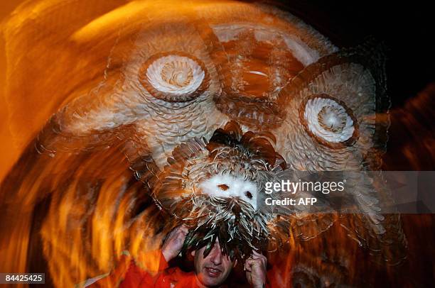 Bulgarian dancer known as a "kuker" performs a ritual dance during the International Festival of the Masquerade Games in the town of Pernik near...