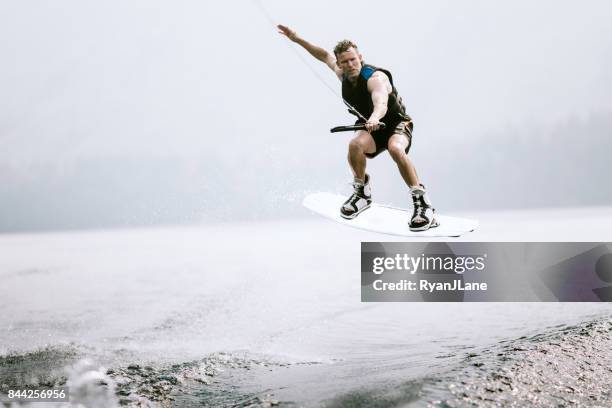 mature man riding wakeboard - wakeboarding stock pictures, royalty-free photos & images