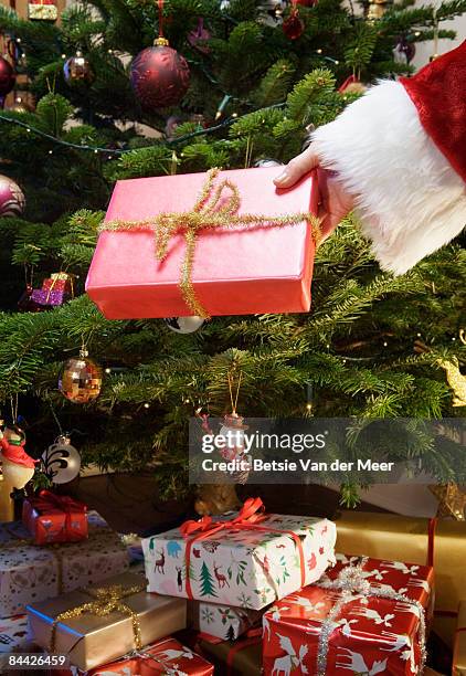 father christmas is giving present. - santa giving out presents stock pictures, royalty-free photos & images