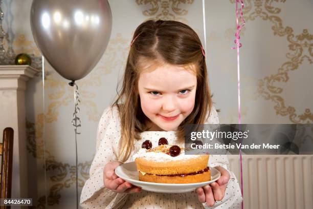 girl is holding her selfmade birthday cake. - hold birthday cake stock pictures, royalty-free photos & images