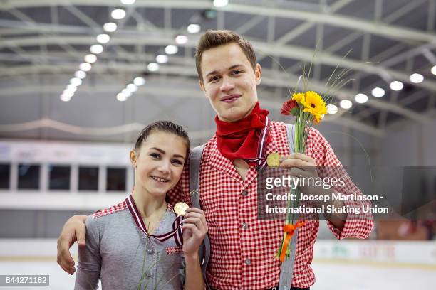 Apollinariia Panfilova and Dmitry Rylov of Russia pose in the Junior Pairs medal ceremony during day 2 of the Riga Cup ISU Junior Grand Prix of...