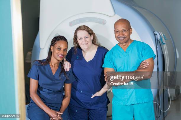 multi-ethnic medical team with mri scanner - mri technician stock pictures, royalty-free photos & images