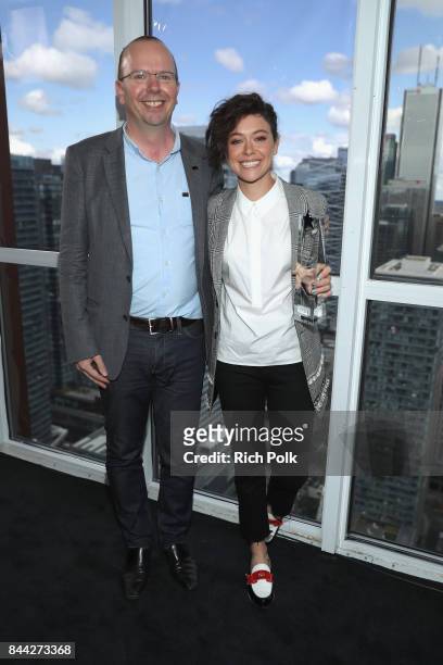 Founder and CEO of IMDb Col Needham presents actress Tatiana Maslany with The IMDb 'Fan Favorite' STARmeter Award In Toronto At The Visa Infinite...